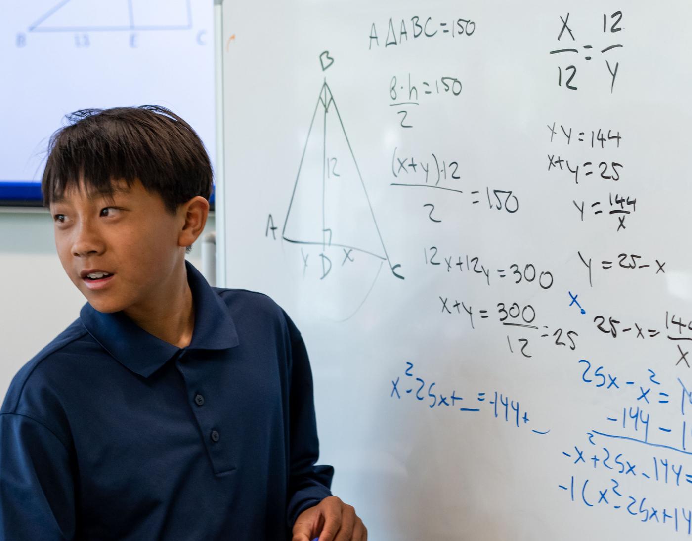 AoPS Middle School or High School student solves problem using equations on whiteboard